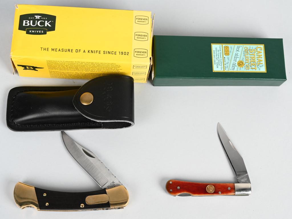 BUCK 110 AUTO KNIFE & CANAL STREET CULTERY KNIFE: Pair of very nice collectible folding knives, both in their original factory boxes. First is a Buck 110 Automatic -- this knife has the traditional look of a Buck folder with wood and brass handle, an