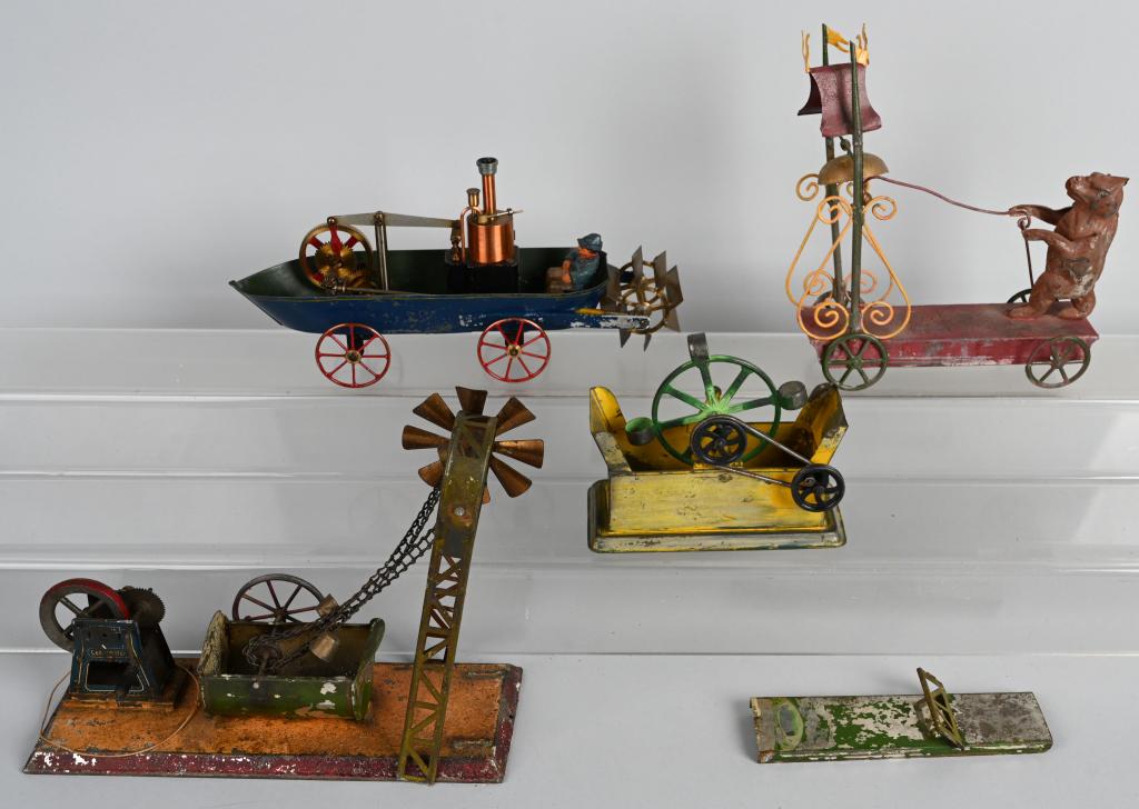 ANTIQUE and CONTEMPORARY TIN TOYS: Lot includes a Steam Water Wheel, a Flywheel Drive Water Well, along with two interesting contemporary toys. Largest is 10", Condition issues. AS-IS