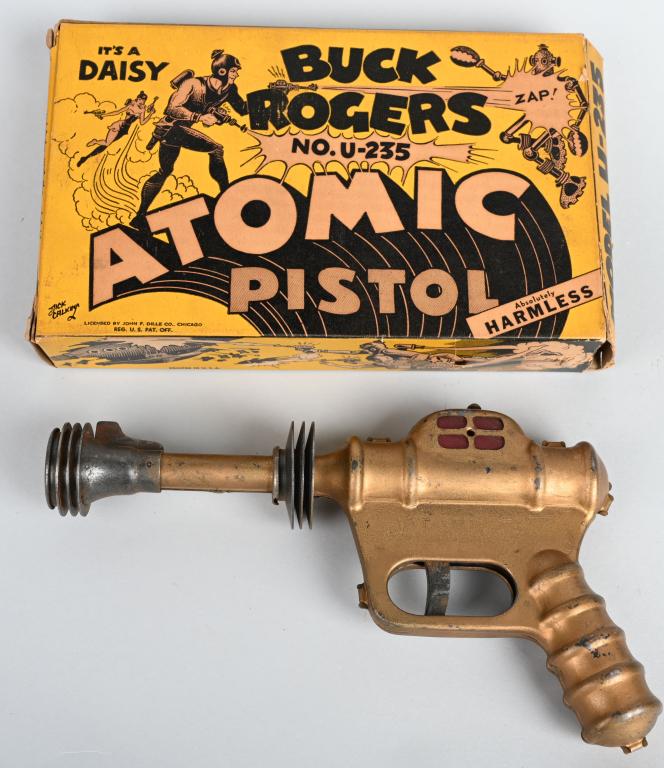 DAISY BUCK ROGERS ATOMIC PISTOL w/ BOX: The Buck Rogers pistol is part of an old store stock find. The pistol works, and has general wear, and scattered light rust. The graphic original box is quite scarce. 9 1/2", Very Good