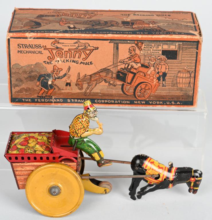 STRAUSS Tin Windup JENNY the BALKING MULE w/ BOX: The toy has nice colors. It is missing the drivers hat brim and the ears on the mule. Not working. The original colorful box has repairs and loose flaps. 8 1/2". Very Good