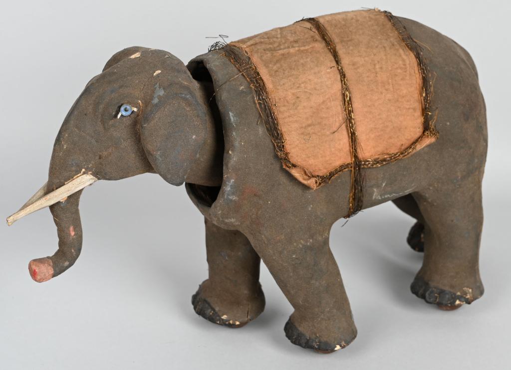 ANTIQUE ELEPHANT NODDER PULL TOY: Great looking early elephant nodder pull toy. Has blue glass eyes. There is an old repair to right rear leg. Overall wear and has a crack in back of head. A scarce early pull toy. 14". Good