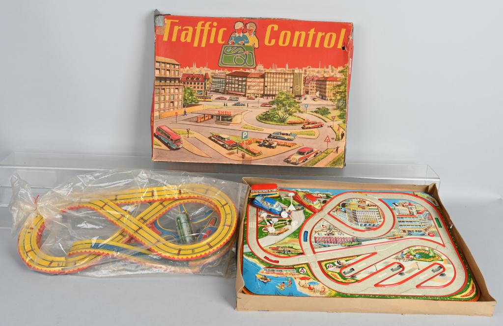 2- GERMAN Tin Windup AUTO TRACK SETS: Nice lot with Traffic Control in the original box with 3 vehicles, along with a unboxed set with 2 buses. All of the windups worked when tested. Box measures 20" by 15". Very Good-Excellent