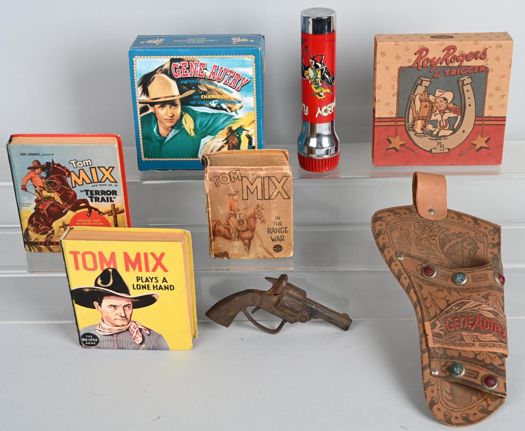 WESTERN COWBOY LOT: Lot includes modern Fossil Gene Autry and Roy Rogers watches, a vintage Cowboy flashlight, old Gene Autry holster, cast iron cap pistol and 3-Tom Mix books. Condition varies. Good-Excellent