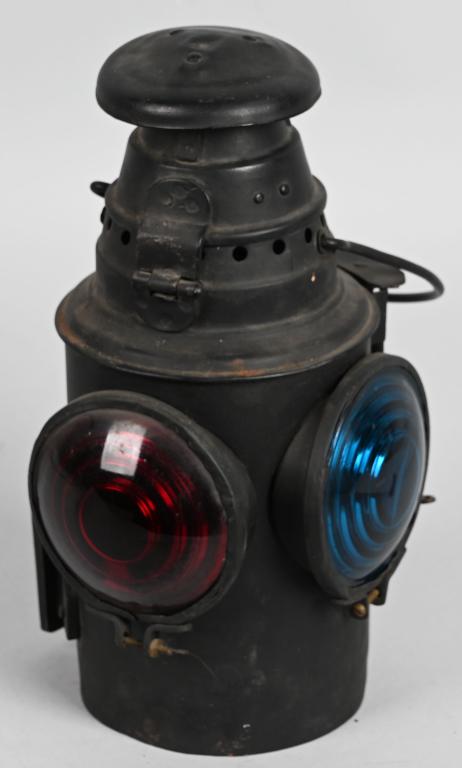 Small Westlake Marker Lamp: rated 7.5, 12"T., in fair to good condition, old repaint, round top, wire bail handle, round base, has Buner, red & blue optical lenses, lower mounting bracket