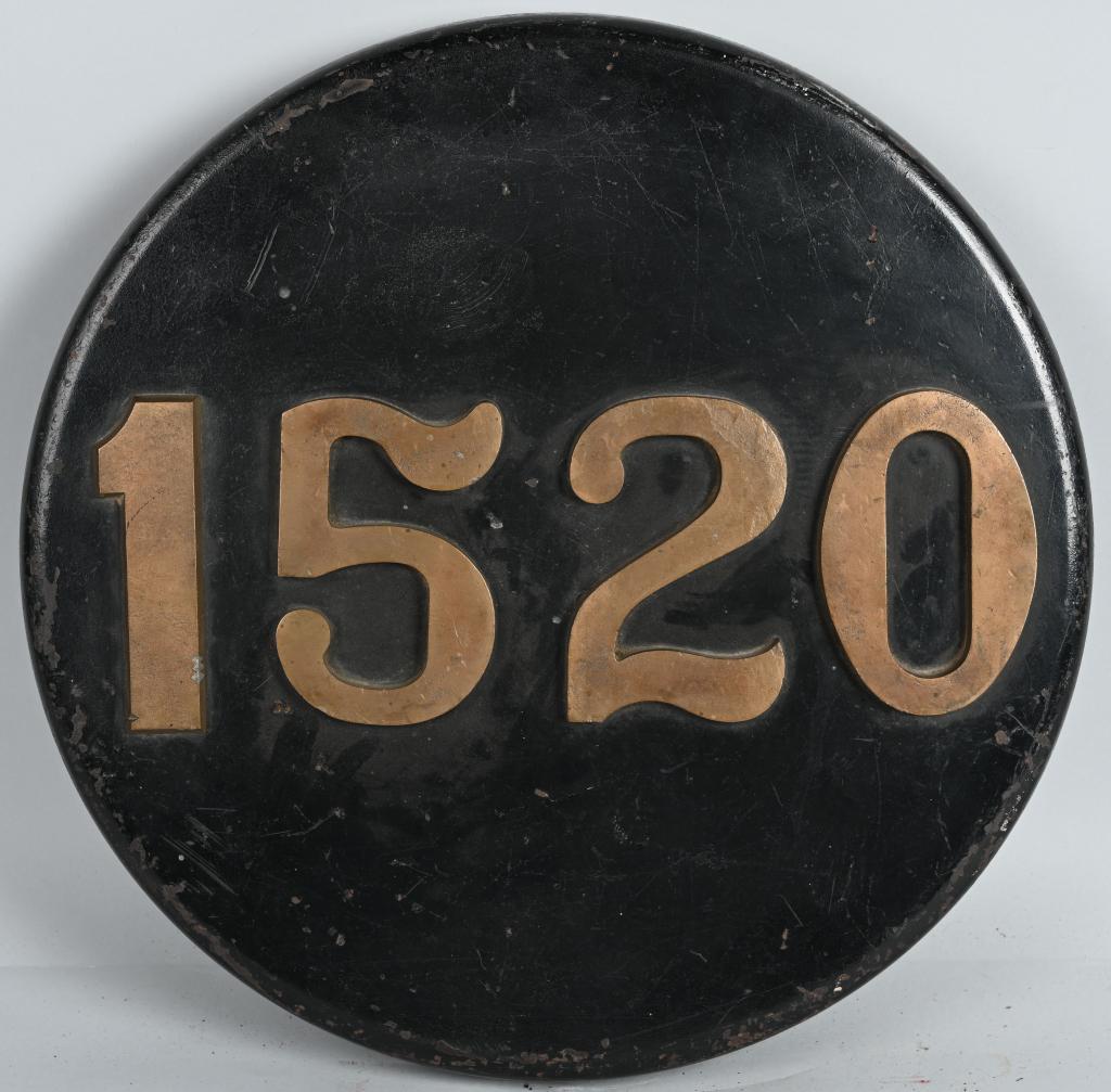 Reading RR #1520, 2-8-0 Camel Back Engine Number P: in very good condition, 20"D., is a heavy cast iron rolled edge plate with bolt on brass numbers and mounting stem, has the numbers A15407 stamped in back, says it was original put on in 1905