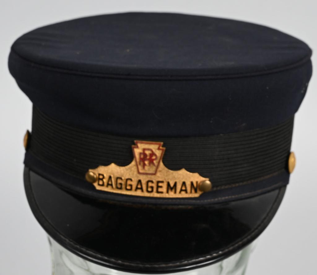 PENNSYLVANIA RAILROAD BAGGAGEMAN HAT: Cloth hat with brass badge with Pennsylvania buttons on each side. Size 6-7/8. Very Good