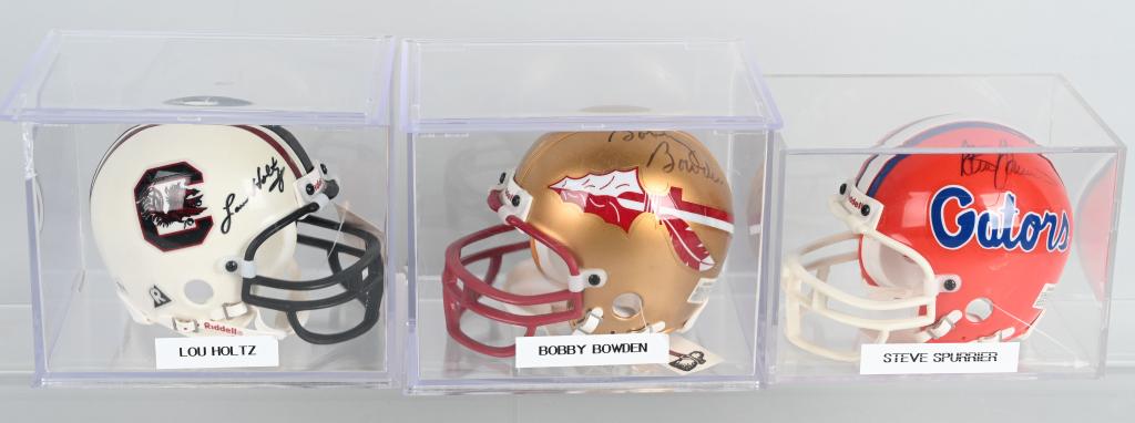 3- COLLEGE FOOTBALL COACH SIGNED MINI HELMETS: Includes Lou Holtz on South Carolina Helmet, Bobby Bowden on Florida State Helmet, and Steve Spurrier on Florida Gators Helmet. All Mini Helmets. All with acrylic cases.