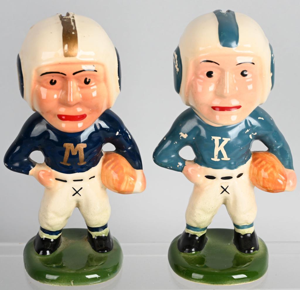 PAIR OF ZANESVILLE POTTERY FOOTBALL BANKS: A pair of 1940's Pottery Coin Banks depicting a Football Player. They measures about 7 3/4" in height and are marked on the bottom in ink stamp Nouvelle Pottery Zanesville, O. One has a K and the othe