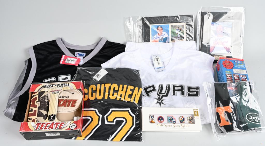 MISC SPORTS RELATED LOT: Includes boxed certified authentic Daiuke Matsuzaka card and some original mound dirt display. Boxed gift set 1996 Olympic Games Gift Set of five pins. Jets and Texas bottle caddies. Boxed Tecate hat 