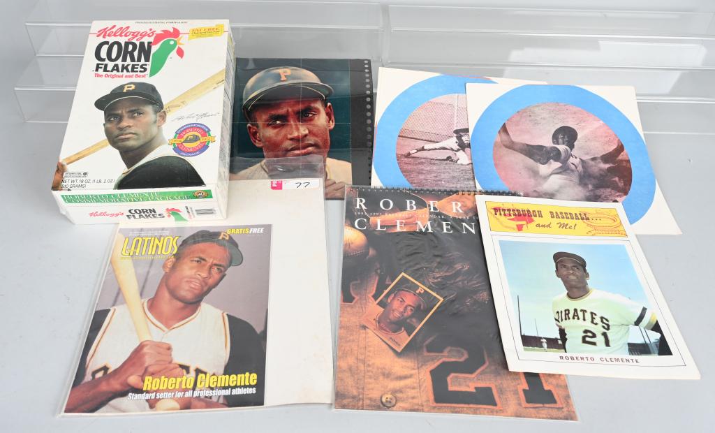 ROBERTO CLEMENTE LOT INC. AUTOGRAPH: Autographed in pen color magazine photo, Latinos magazine, Pittsburgh Baseball magazine, 8 assorted picture discs, Corn Flakes box and calendar.