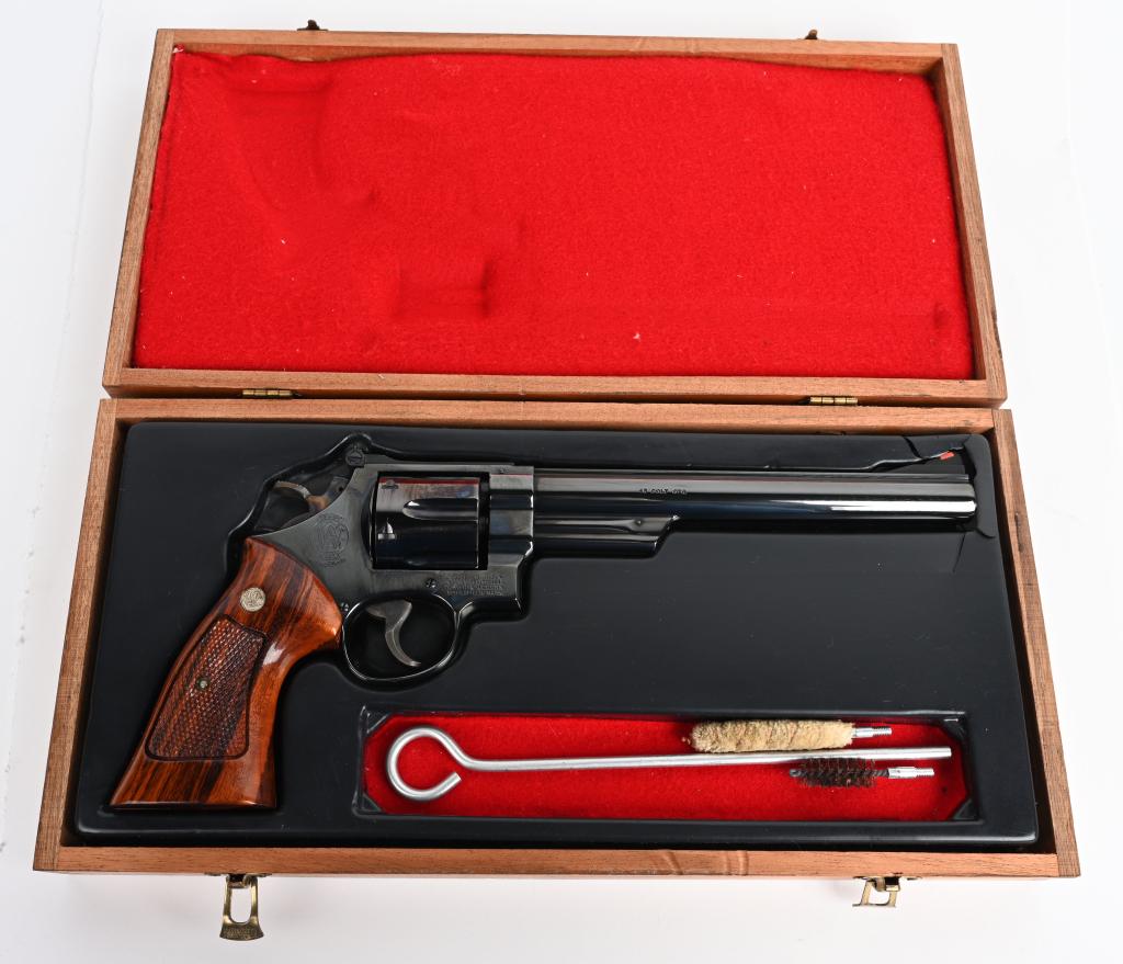CASED SMITH & WESSON MODEL 25-5 REVOLVER: SERIAL N660055. BARREL 8 3/8". CALIBER .45 COLT. Near mint high polish blue with long barrel, six shot, double action, solid rib, red insert front sight, target rear sight, case color wide target trig