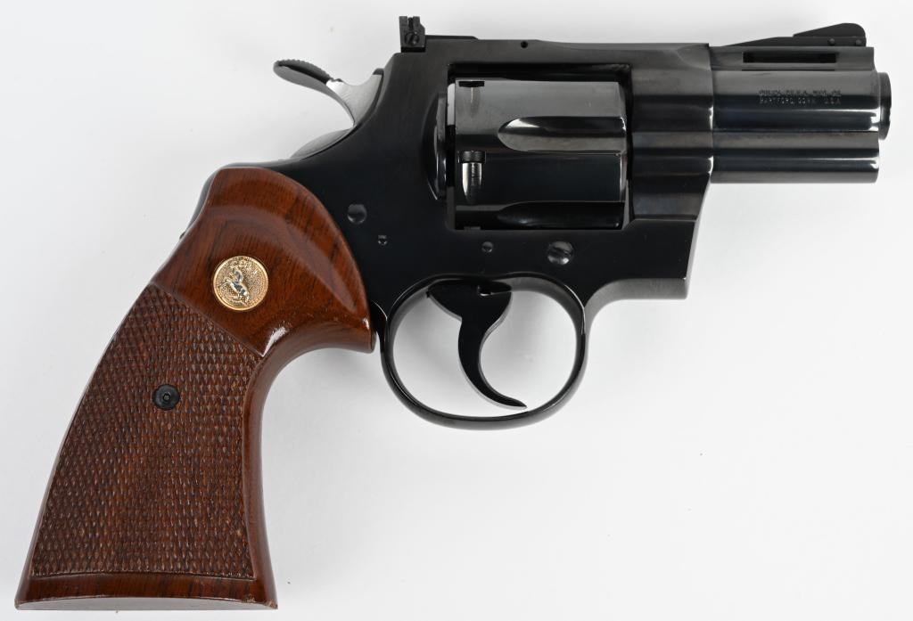 BLUE 2 1/2" COLT PYTHON REVOLVER: SERIAL 78744. BARREL 2.5". CALIBER .357 MAGNUM. MADE IN 1968. Very faint drag line and test fire face burn only. Near new with maybe a handling mark on metal and couple of dings on gold medallion chec