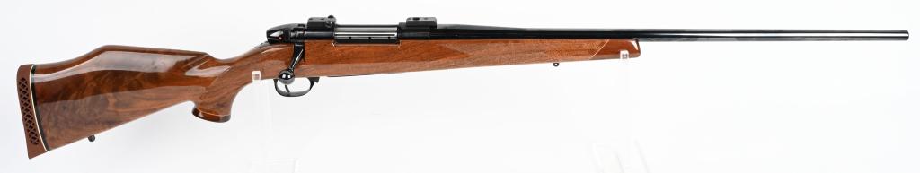 WEATHERBY MARK V BOLT ACTION RIFLE: SERIAL H245347. BARREL 26". CALIBER .30-06. This is the classic Weatherby. Stock features the rakish Monte Carlo comb, diamond skip checkering, rosewood grip cap and fore-end tip with high gloss finis