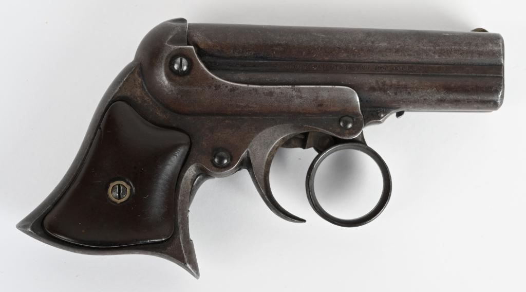 REMINGTON ELLIOT 4-BARREL DERRINGER: SERIAL 9764. BARRELS 3 1/4". CALIBER .32 RIMFIRE. MADE 1863-1888. Features 4-shot stationary barrel cluster with revolving firing pin. Activates via ring trigger, barrel tilts forward for loading. Iro