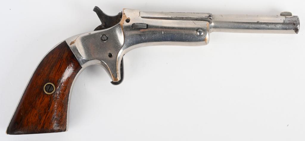 SMALL POCKET STEVENS SINGLE SHOT PISTOL: SERIAL 266164. BARREL 3 5/8". CALIBER .22 RIMFIRE. This is a Model 41 made from 1898-1902. Features nickel finish, spur trigger, tip up, no rear sights, walnut grips and no extractor. 90% original fin