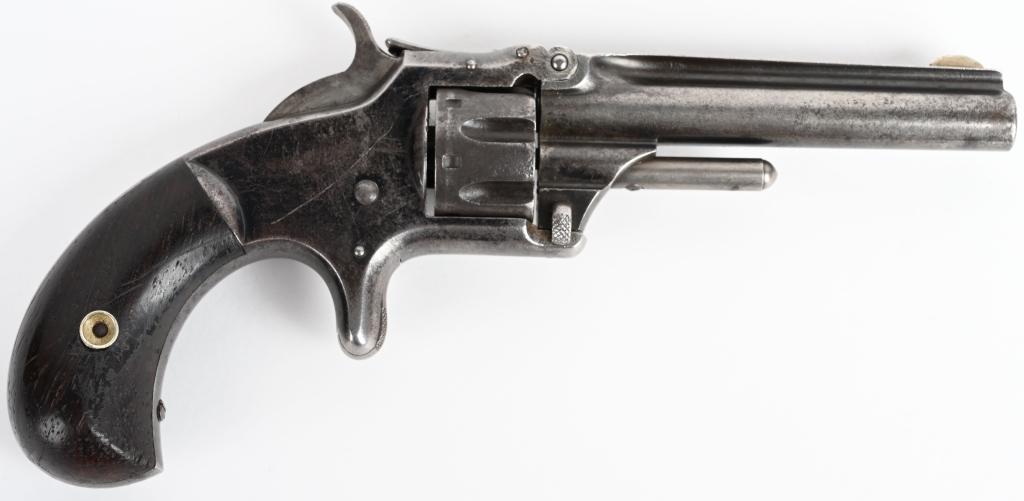 SMITH & WESSON NO. 1 1/2 SPUR TRIGGER REVOLVER: SERIAL 44116. BARREL 3.25 ". CALIBER .22 RIMFIRE. Features round barrel, 7-shot, single action with blue frame and rosewood grips. Barrel and cylinder are patina. Frame retains traces of original blue