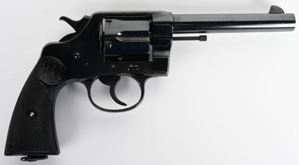 EARLY COLT NEW SERVICE DOUBLE ACTION REVOLVER: Serial #19211. Barrel length 5 1/2". Caliber .45 Colt. Made in 1907. Early barrel without taper. Standard blue finish with Colt gutta percha grips and lanyard ring. This revolver retains approximately