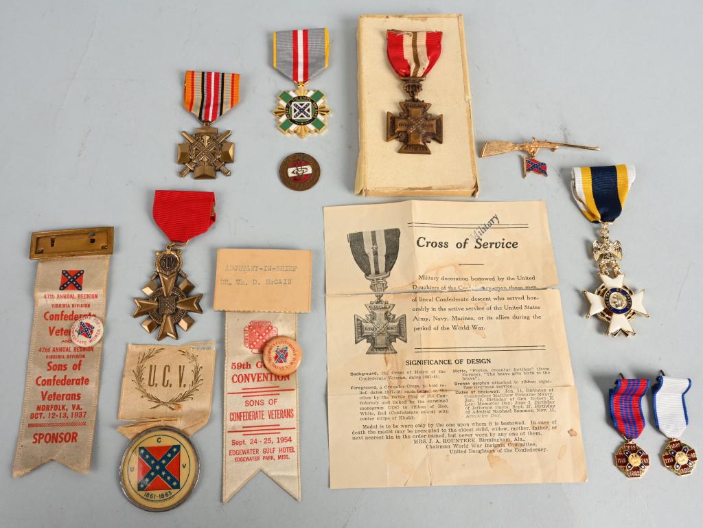 CONFEDERATE REUNION BADGE LOT UCV SONS OF VETERANS: Large grouping of UCV and Sons of Confederate Veterans badges to include 1) Boxed UDC Service/Southern Cross. 2) Order of the Stars and Bars medal 3) Sons of Confederate Veterans Service Medal. 4) Ord