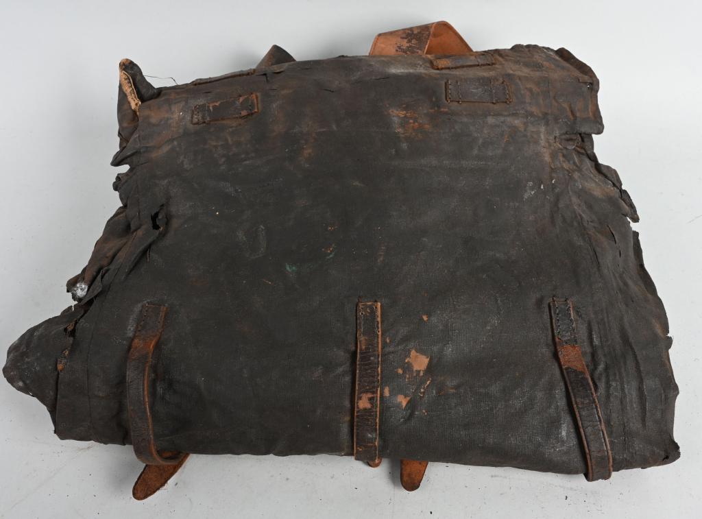 CIVIL WAR TARRED CANVAS US FEDERAL BACKPACK 1864: Tarred canvas Union Civil War backpack, approx. 18" x 18 1/2" (closed), with shoulder straps present and intact dated 1864, showing original brass fittings. Canvas is still supple but does show signs 
