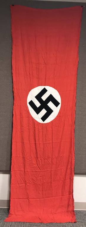 WWII NAZI GERMAN NSDAP WALL BANNER W/ RINGS WW2: Multi-piece cotton construction banner approximately 50 x 150 inches. To both its red fields are sewn white disks, with a printed mobile swastikas in black. Shows the expected period use and wear but 