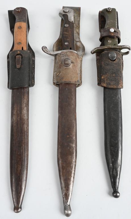3- WWI IMPERIAL GERMAN & TURKISH BAYONETS & FROGS: Lot of 3 WWI era German and Turkish bayonets with frogs & scabbards. Includes a German M1898/05 Turkish modified fullere-d blade bayonet with a diagonal grooved wood grip and a metal scabbard; a Gerna