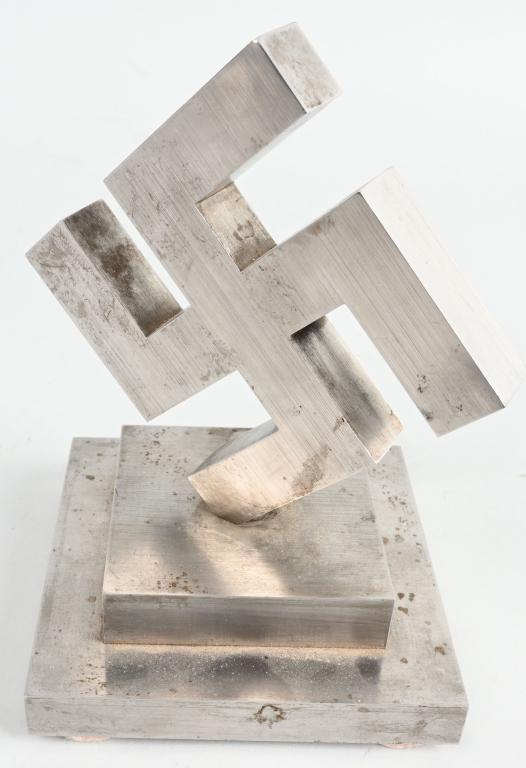 WWII NAZI GERMAN METAL DESK OR TABLE SWASTIKA WW2: Large metallic canted swastika made from a very low magnetic metal measuring 7 inches tall and being very heavy, about 10 pounds. I think this was produced is a Aircraft factory by a very talented mac