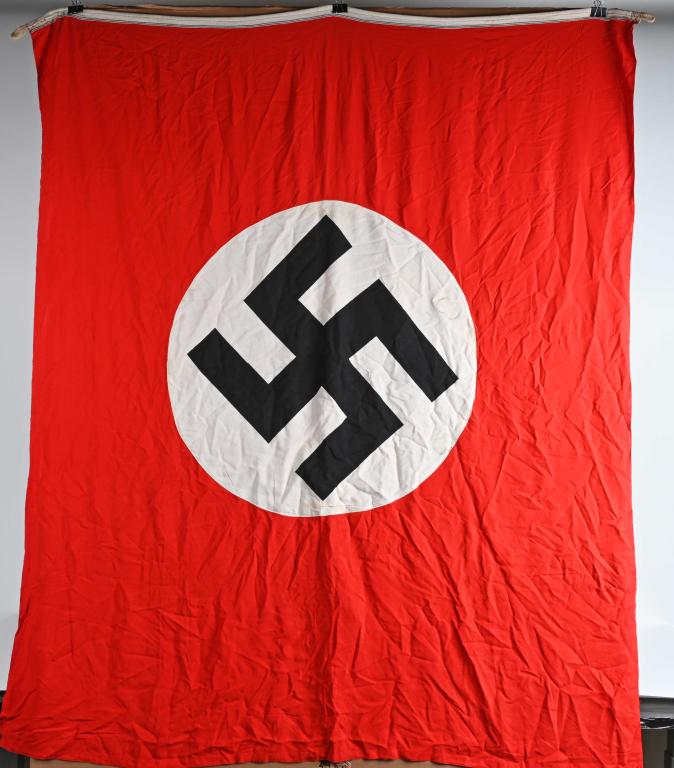 WWII NAZI GERMAN NSDAP WALL BANNER FLAG WW2: A large multi-piece cotton construction banner approximately 65 X 53 inches. To both its red fields are sewn white disks, with a sewn on mobile swastikas in black. There is a tunnel loop to each end. 