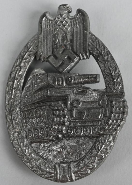 WWII NAZI GERMAN PANZER ASSAULT BADGE SILVER WW2: Die struck alloy construction, solid backed, badge with a silver washed finish features a vertically oval, oak-leaf wreath with a Wehrmacht style eagle with down-swept wings, clutching a canted swasti