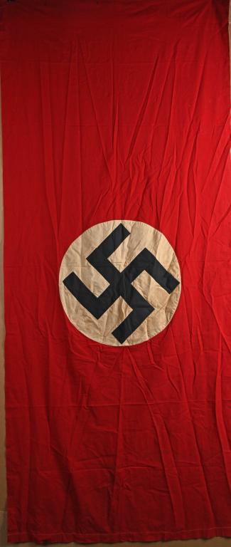 WWII NAZI GERMAN NSDAP NATIONAL FLAG OR BANNER WW2: Multi-piece cotton construction banner approximately 38 x 86 inches. To both its red fields are sewn white disks, with a printed mobile swastikas in black. Shows the expected period use and wear but o