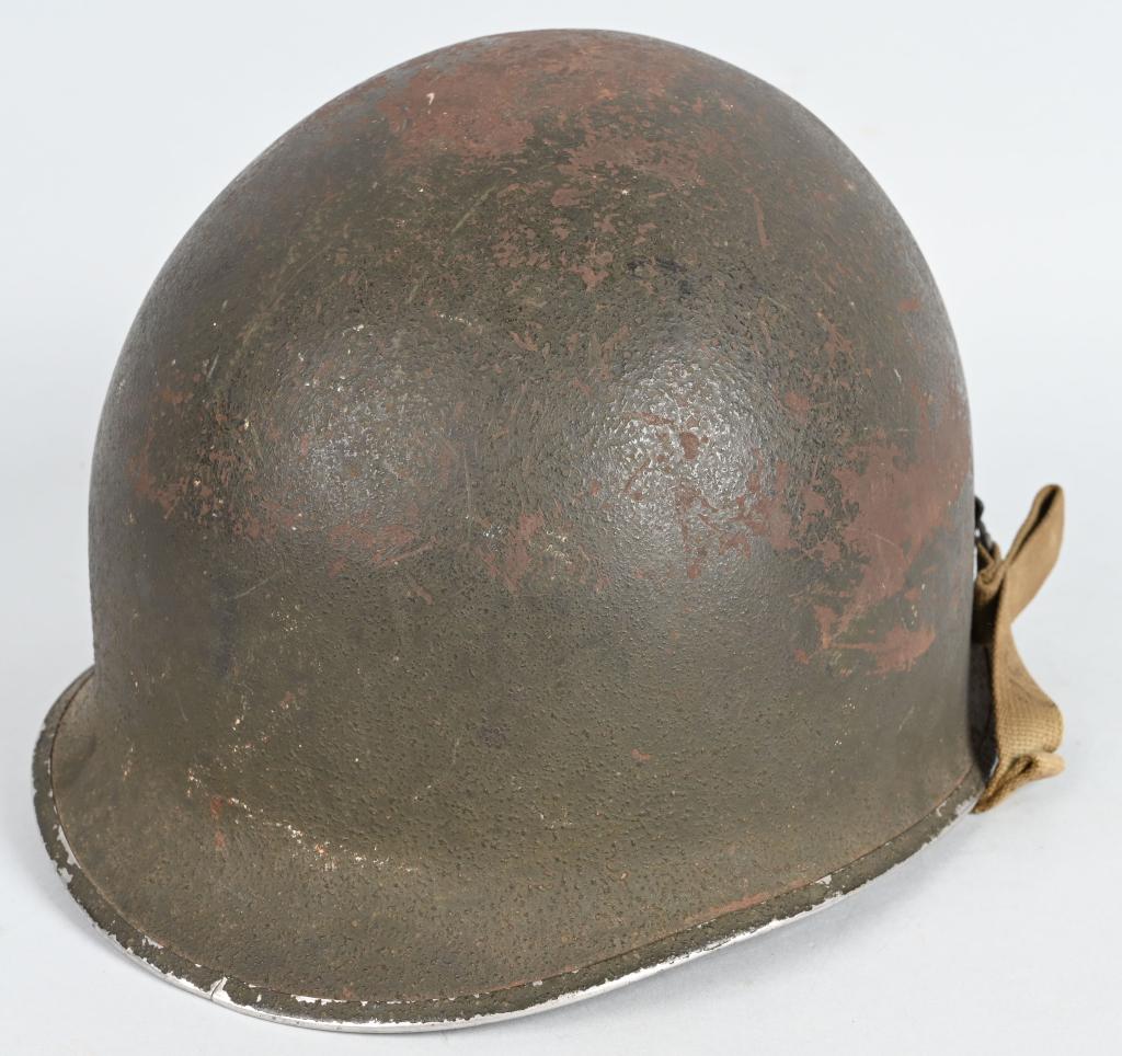 WWII US ARMY FIXED BAIL M1 HELMET FIRESTONE LINER: Early World War II front seam, fixed bale M1 "Steel Pot" style helmet with sewn khaki chinstraps, cork textured OD green paint with a heat lot of 637F. Liner has khaki webbing, and unpainted A-washers
