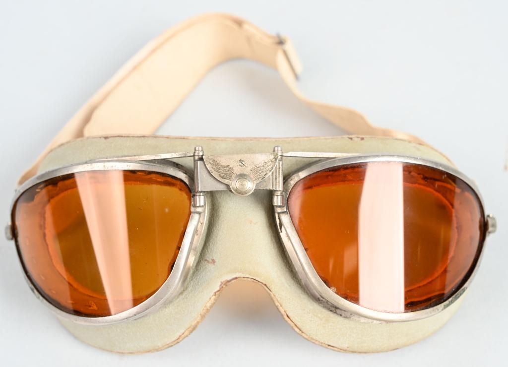 WWII US ARMY AIR CORPS FLIGHT GOGGLES AO WW2: WWII US Army Air Force flying goggles made by AMERICAN OPTICAL with "AO" maker's mark on the adjustable bridge. Orange rock glass lenses. Goggles are in excellent condition.
