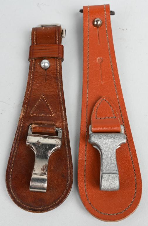 WWII NAZI GERMAN OFFICER'S SWORD HANGER LOT OF 2: Tan leather tear drop shaped hanger lot of two with leather reinforced, silver washed, steel friction carbine hook to front center. Leather tab tapers inward towards top edge and has a fold over strap