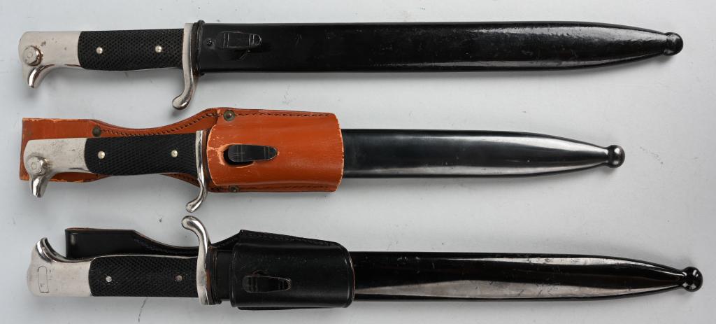 WWII NAZI GERMAN DRESS BAYONET LOT OF 3 WW2: A grouping of three WWII Nazi German dress bayonets to include 1) Marked "WKC" with a knight logo at the ricasso. 9.8" blade with a 1.8" false edge, 14.6" overall length. Has black composite grips and