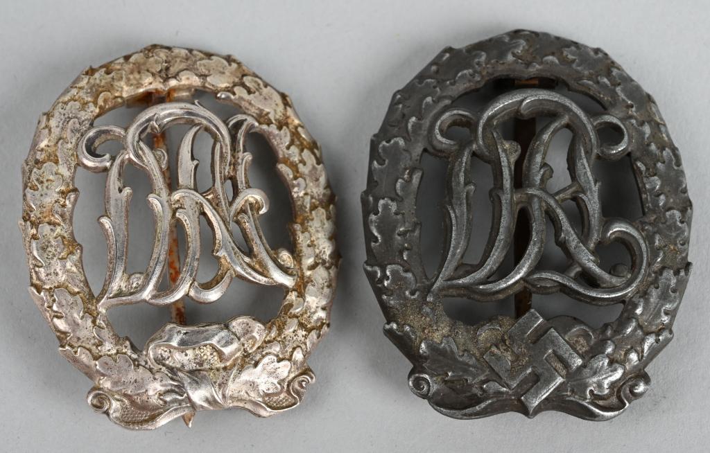 WWII NAZI GERMAN DRL SPORTS BADGE SILVER BRONZE: WWII Nazi German DRL Sports badge lot of two to include 1) A 1937 pattern, die struck alloy award with a nickle/silver finish. The badge is in the form of a 50mm tall, vertical oval oak leaf wreath, w