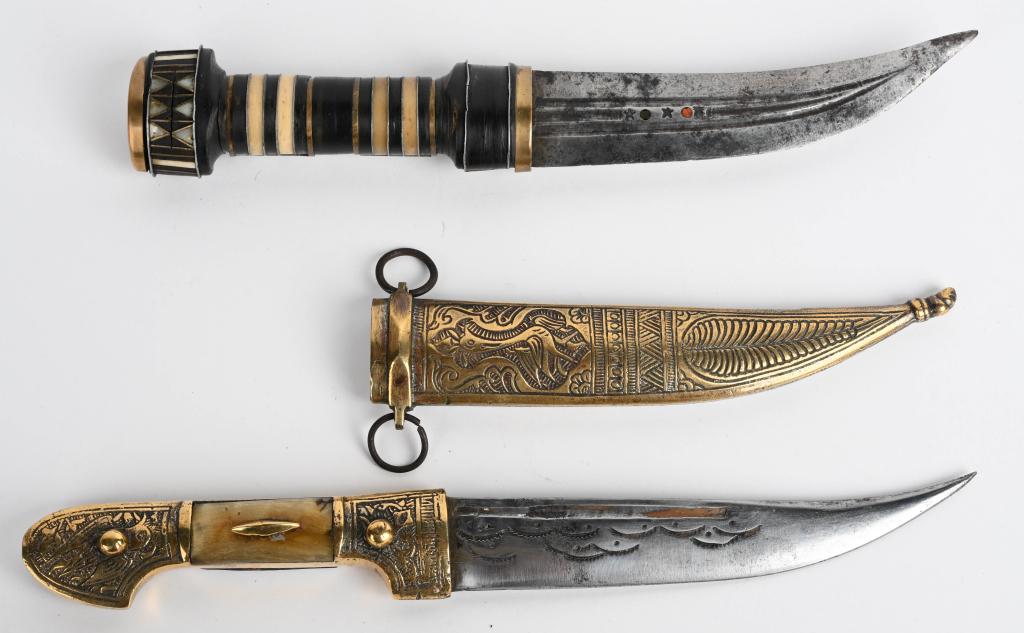 PAIR OF EARLY SYRIAN JAMBIYA DAGGERS: Two very nice early Syrian curved blade daggers. One comes with a sheath with the word "SYRIA" below the throat, decorated with aviary motifs and has a star and crescent pattern on the blade. Blade is