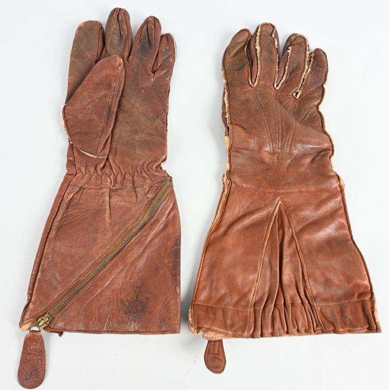 WWII 1941 RAF GAUNTLET LEATHER FLYING GLOVES NAMED: A beautiful pair of supple brown leather Air Ministry issued Flying Gauntlets as used by the RAF during the Battle of Britain. These pair were in fact issued in 1941 and bear the Crown and AM stamp al