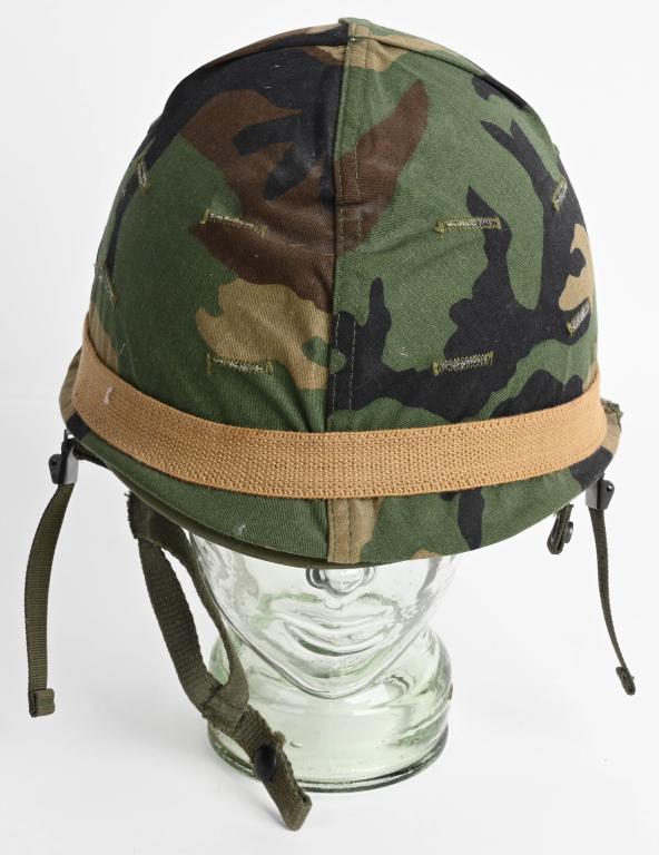 1980s US ARMY & MARINE CORPS M1 STEEL HELMET: Appears unissued. Ground Troops style helmet with complete liner and chinstraps as well as BDU 3-color woodland camouflage cover. NSN dated on the inside to 1983 contract production. Nylon j-hook chin