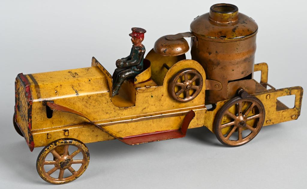 SCHIEBLE PRESSED STEEL FLYWHEEL FIRE BOILER TRUCK: Very nice early Schieble Fire Boiler Truck. All original with nice paint. Looks to have been shellaced at some point. Flywheel mech works. A great looking early primitive Fire Truck. 14 1/2" Excellent