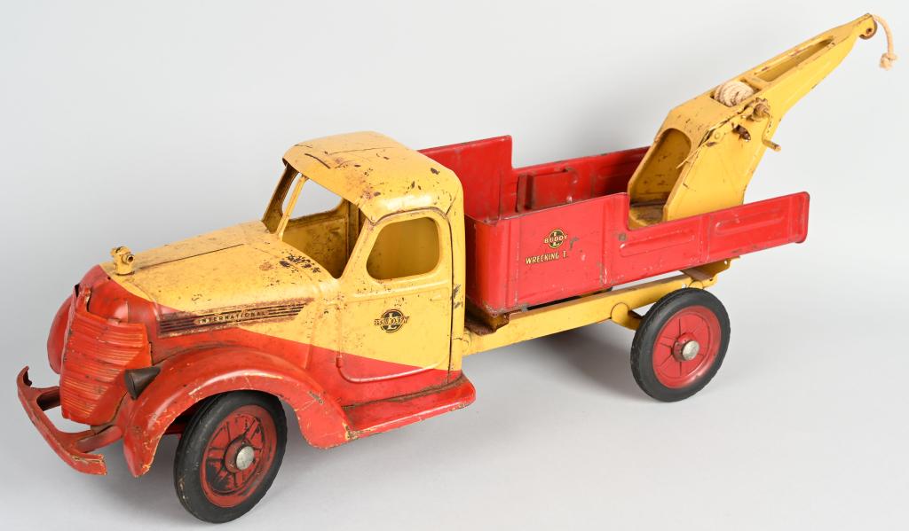 BUDDY L PRESSED STEEL 1938 WRECKING TRUCK: Original 1938 International Wrecking Truck. All original paint and decals. This was a ride-on truck. Seat and steering handle missing. Displays well. 28" Very Good