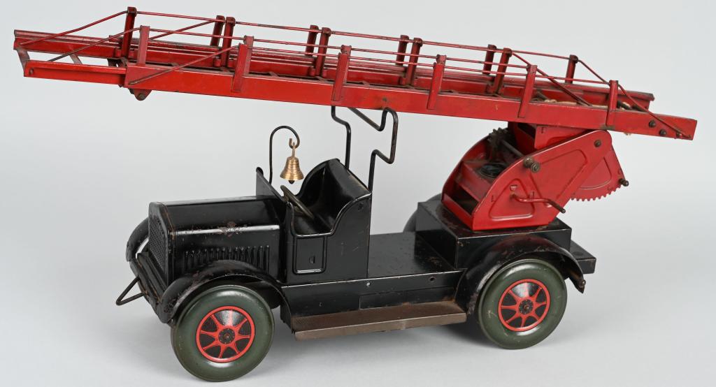 UNUSUAL PRESSED STEEL LADDER FIRE TRUCK: Very unusual Ladder Fire Truck. Possibly European? All original and complete. Very detailed with a complex working ladder. Nice original factory paint. A great looking truck we have not seen before. 2