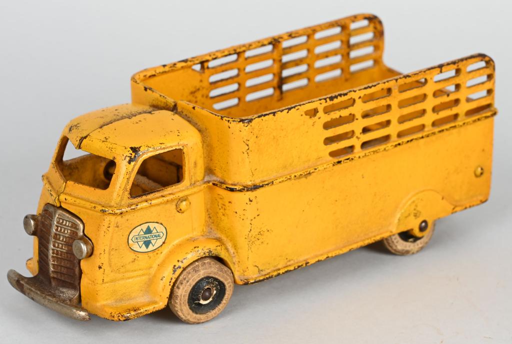 ARCADE CAST IRON INTERNATIONAL CAB OVER TRUCK: Original Arcade International Can Over Stake Truck. Nice factory paint and decals. Has original white rubber tires. A nice looking truck. 9 1/2" Very Good-Excellent