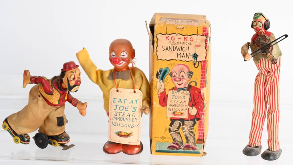 3- JAPAN WINDUP CLOWNS: Includes KOKO Sandwich Man missing hands with box, TPS Clown Skater, and TPS Clown with Violin. All working. Largest 9" Very Good