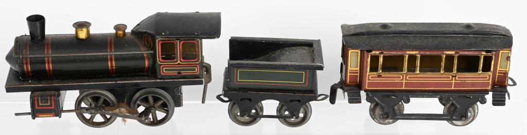 GERMAN O GA CLOCKWORK 3 PIECE TRAIN SET: Nice German O gauge clockwork 3 piece Train Set. Includes Engine and Tender with Passenger Car. Working and in nice condition. Engine measures 6" Excellent