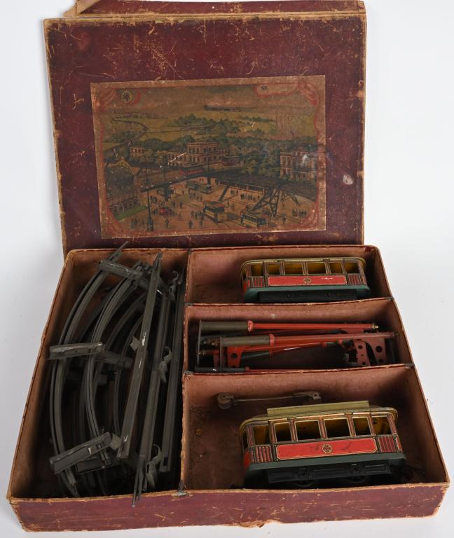 CARETTE O GA TROLLEY & TRAILER SET w/ BOX: Wonderful original Carette O gauge Trolley and Trailer Set. Trolley and Trailer are all original red color with great details. Set is complete with Track and Catenary Poles. With original Box. Trolley