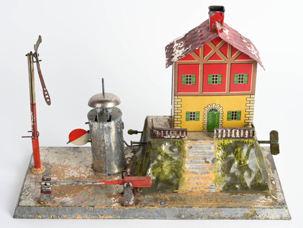 MARKLIN CLOCKWORK CROSSING HOUSE: Early Marklin clockwork Crossing House. All original complete condition. Hand painted with litho house. Has some paint flaking mostly on base. Clockwork needs repair. 12 1/2" x 9 1/2" Very Good