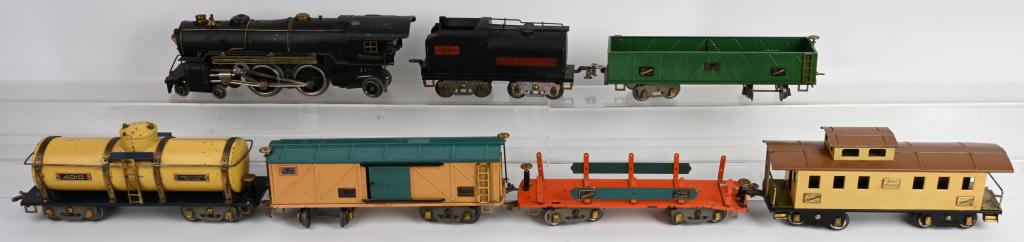 AMERICAN FLYER 4696 LOCO & TENDER w/ 5 CARS: American Flyer standard gauge 4696 Locomotive. Rear steps broken but present, missing valves and bell ringer. Comes with 4694 Tender. Cars includes 4017 Gondola, 4018 Box Car, 4010 Tanker Car, 4022 Fl
