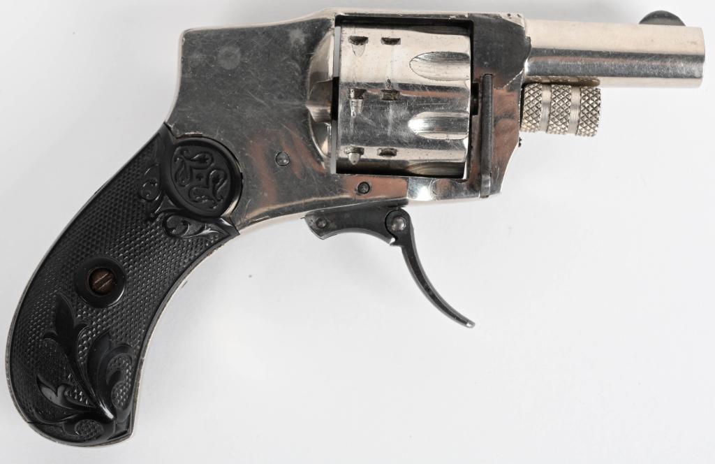 FINE BABY HAMMERLESS DOUBLE ACTION REVOLVER: NSN. BARREL 1.5". CALIBER .22 RIMFIRE. Very rare 8-shot .22 short. Last patent date is1888. This example has never been fired and beside one small missing flake on frame, retains 99% original nickel w