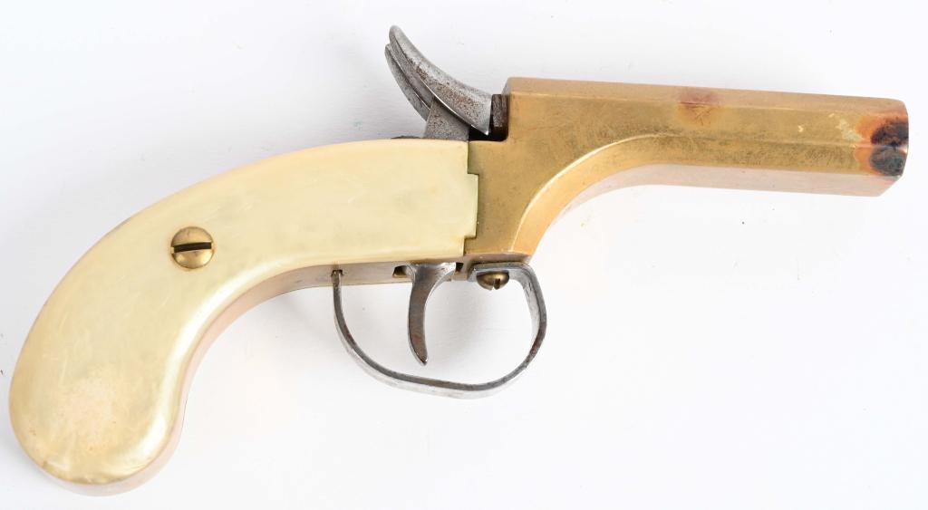 REPRODUCTION BRASS FRAMED DOUBLE MUFF PISTOL: SERIAL NUMBER 22340, BARREL 3-1/8" CALIBER .36 SMOOTH BORE, MANUFACTURE NAVY ARMS. .36 caliber Brass framed double Derringer or Muff pistol with faux mother of pearl grips. Single trigger fired single
