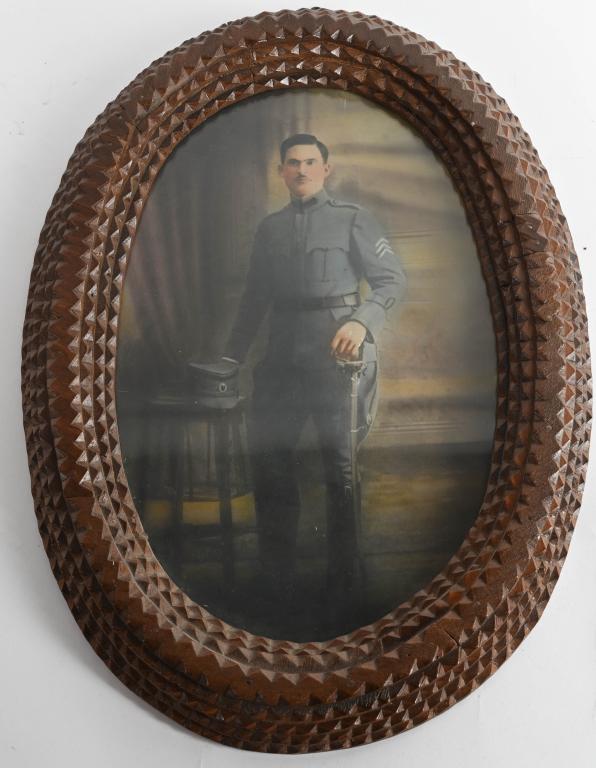 WWI PHOTOGRAPH OF POLISH CAVALRY SOLDIER: Hand tinted photograph of a Polish cavalry soldier housed in a spectacular tramp art frame. The image itself is 14 & 1/2" x 9 & 1/4" and is housed in a 18& 1/2" x 13&1/4" frame. Excellent.