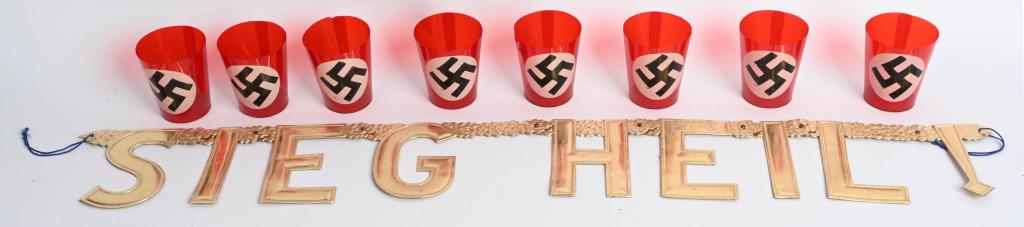 WWII NAZI FUNERAL CUPS & SIEG HEIL CHRISTMAS SIGN: WWII Nazi German lot to include 1) 8 WWII NAZI GERMAN CELLULOID FUNERAL CANDLE CUPS. Red NSDAP swastika with paper bottoms. Show age. Very good. 2) PRESSED GILDED PAPER SIEG HEIL! CHRISTMAS SIGN. Unus